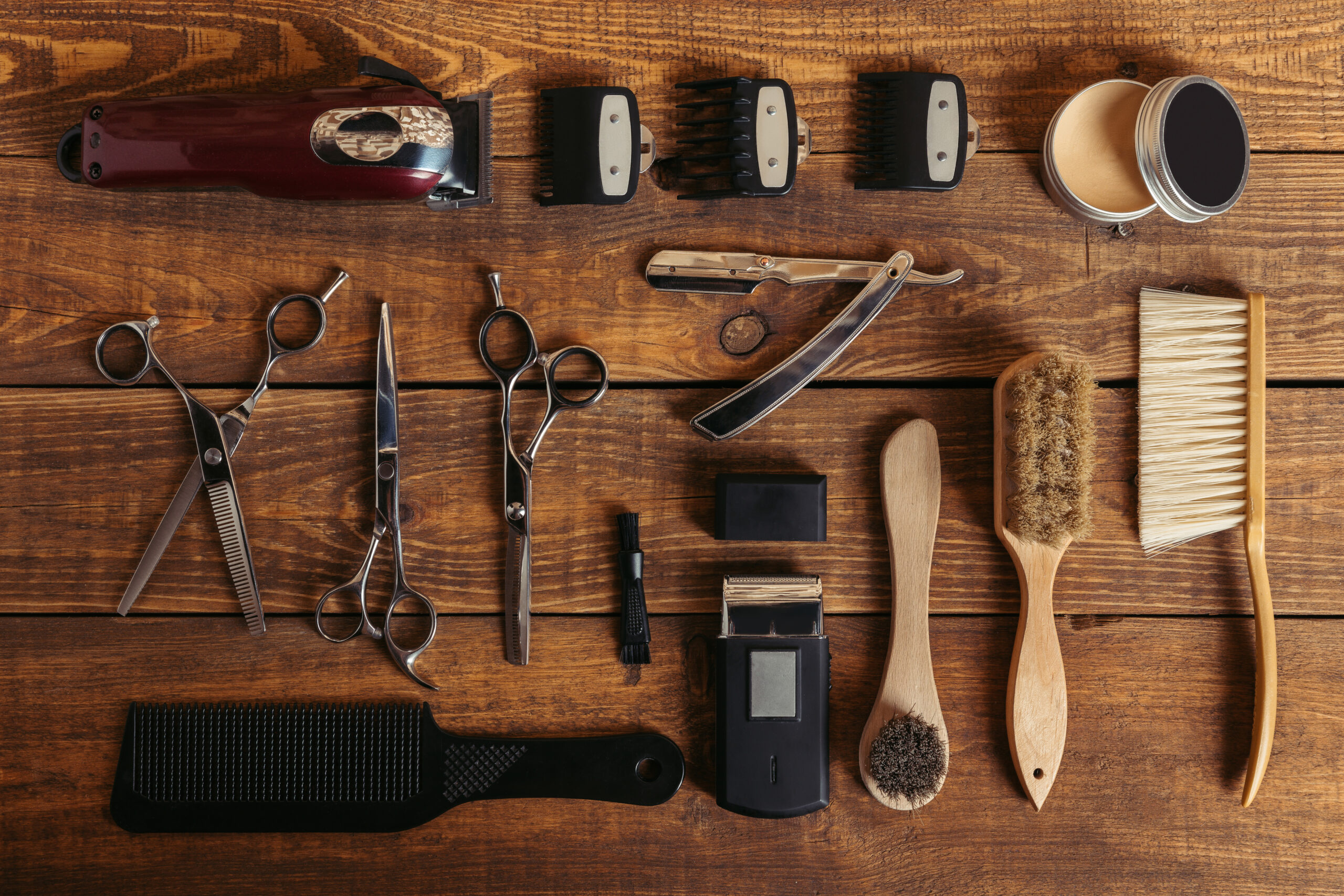 top view of professional hairdressing equipment on wooden table in barbershop